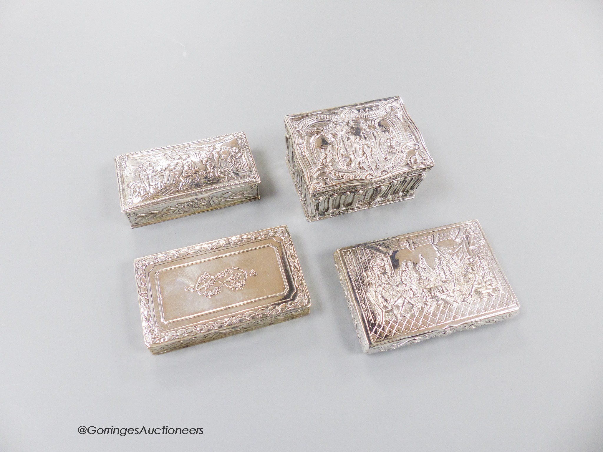 Three early 20th century German 800 standard white metal snuff boxes and one other continental white metal box, largest 86mm, 11.5 oz.